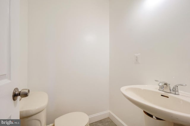 1636 N Bentalou St, Baltimore, MD 21216 - bathroom featuring a sink, baseboards, and toilet