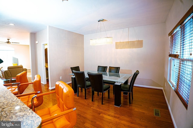 dining area with visible vents, ceiling fan, baseboards, and wood finished floors