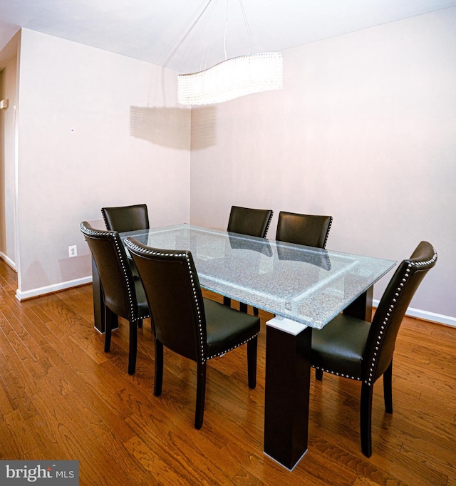 dining area featuring baseboards and wood finished floors