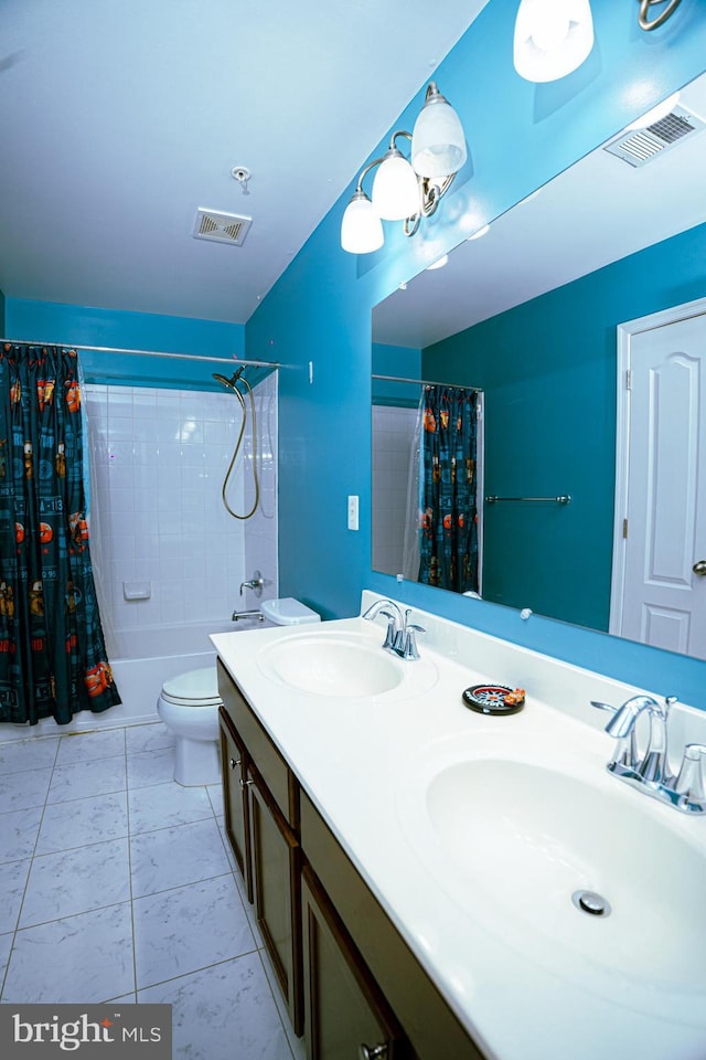 bathroom with toilet, a sink, and visible vents