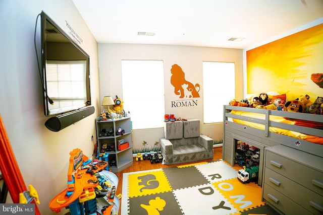 playroom featuring wood finished floors and visible vents