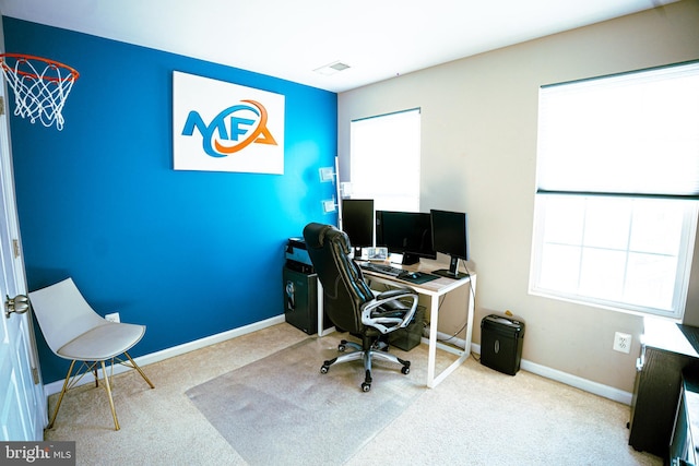 carpeted office space with visible vents, a wealth of natural light, and baseboards