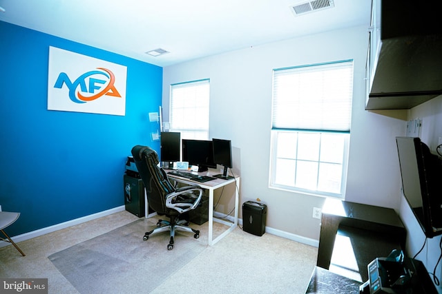 office featuring carpet flooring, visible vents, and baseboards