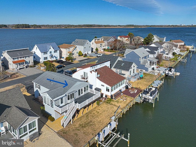 bird's eye view with a residential view and a water view