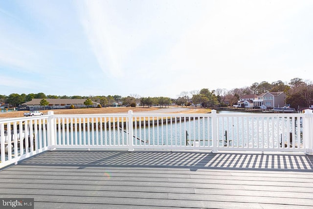 deck featuring a water view and a residential view