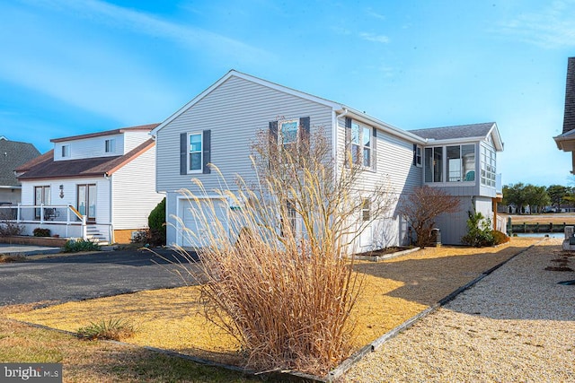 view of side of property with a garage and driveway