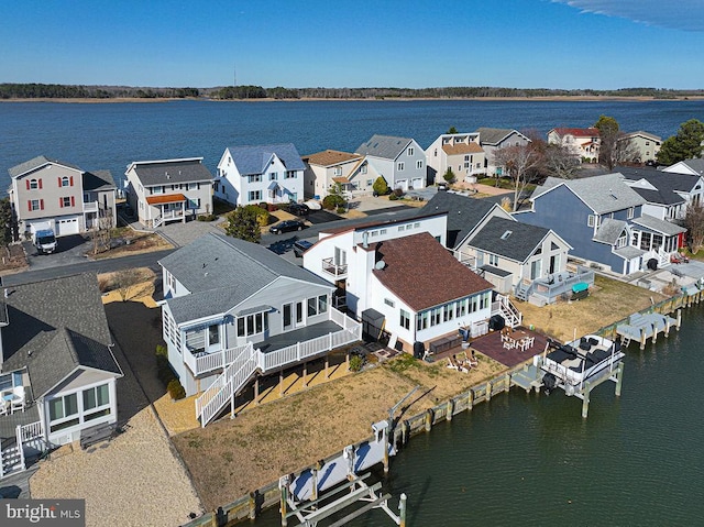 bird's eye view with a residential view and a water view