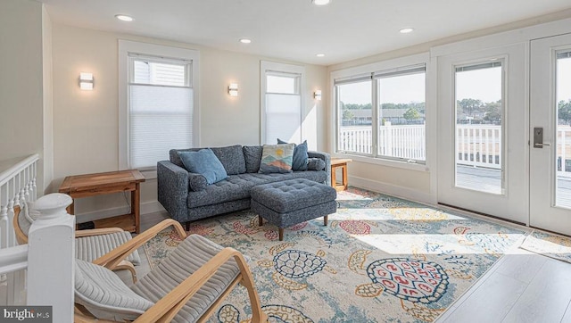 living area with recessed lighting, baseboards, and wood finished floors