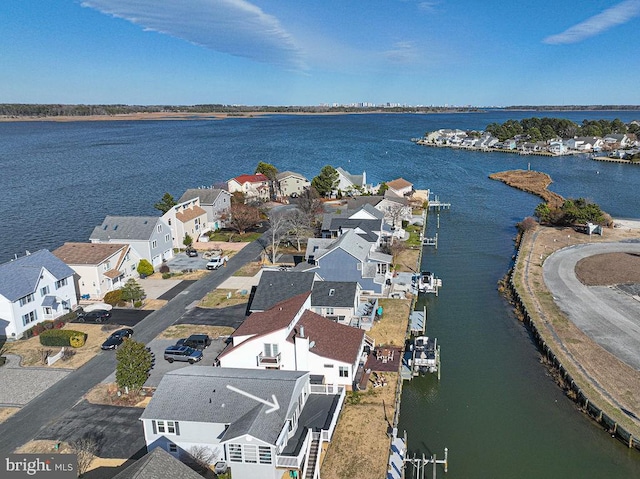 drone / aerial view with a residential view and a water view