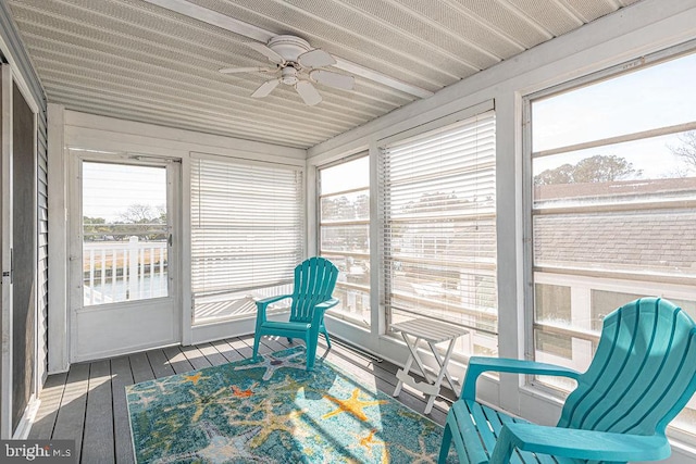 sunroom / solarium featuring ceiling fan and plenty of natural light