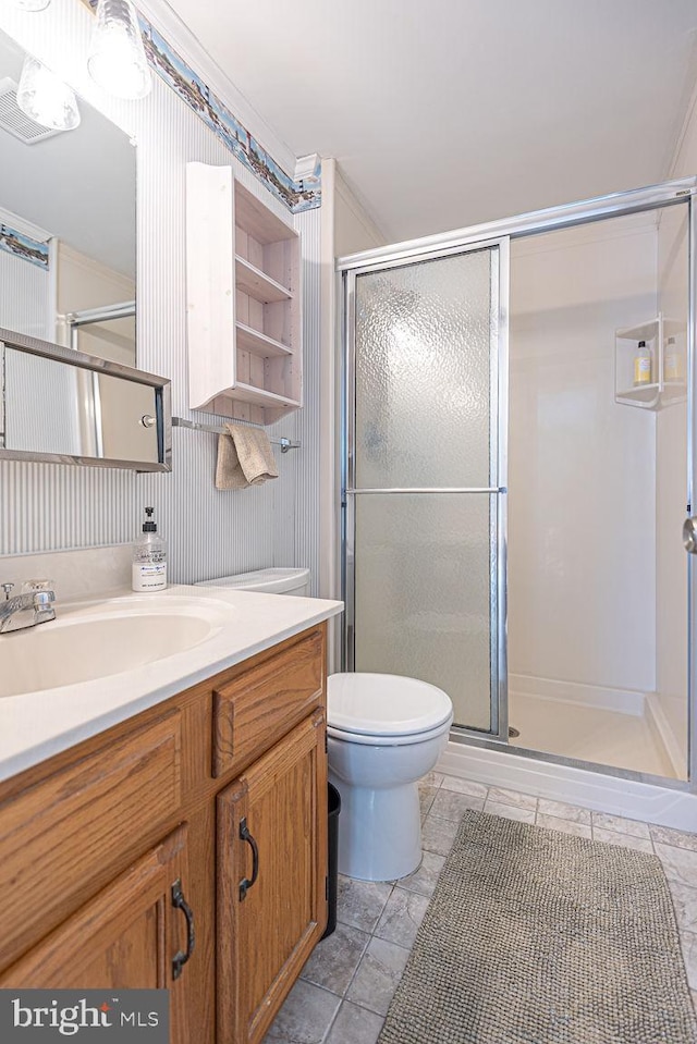 bathroom with vanity, a shower stall, and toilet