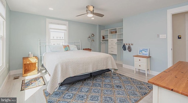 bedroom with baseboards, visible vents, a ceiling fan, wood finished floors, and recessed lighting