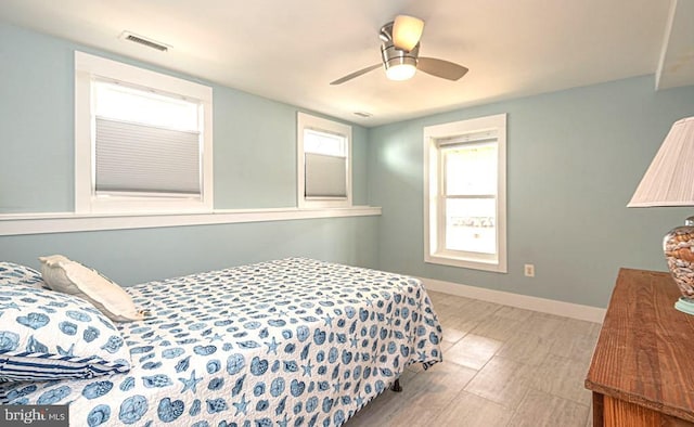 bedroom with visible vents, baseboards, and a ceiling fan