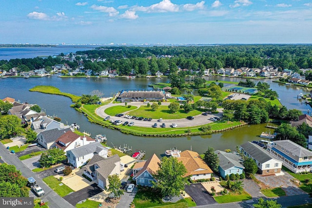 drone / aerial view with a water view and a residential view