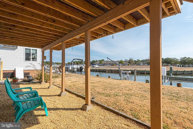 view of yard with a water view and a boat dock