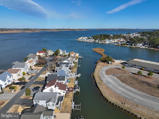 drone / aerial view with a water view and a residential view