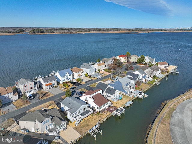 drone / aerial view featuring a water view and a residential view