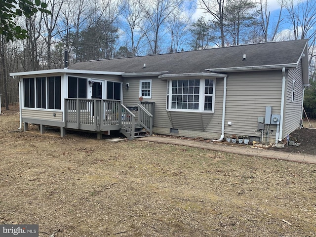 view of front of home with crawl space, a sunroom, a deck, and roof with shingles