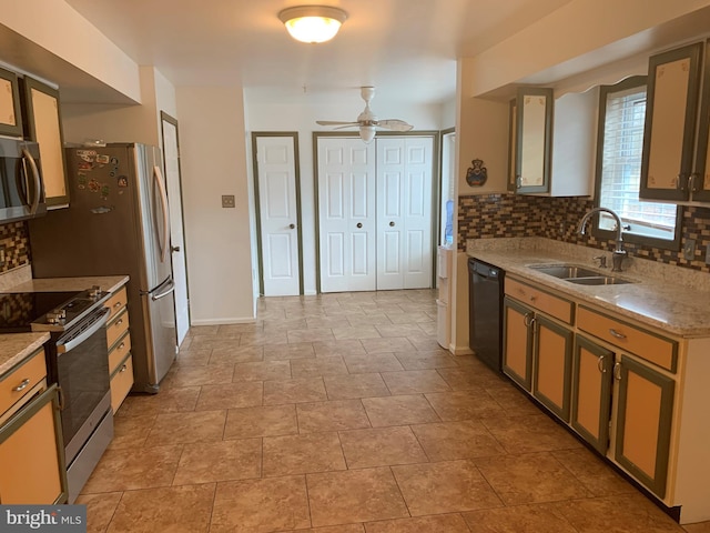 kitchen featuring appliances with stainless steel finishes, a sink, and decorative backsplash