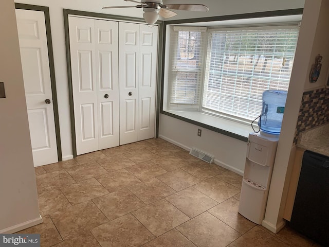 unfurnished bedroom with ceiling fan, a closet, visible vents, and baseboards