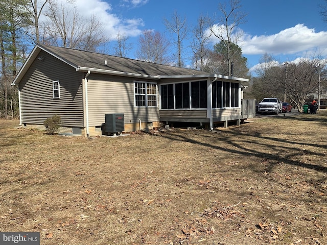 back of house with a sunroom and central AC