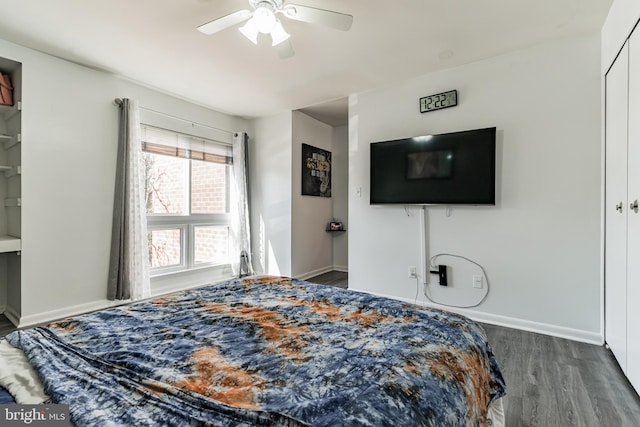 bedroom with ceiling fan, baseboards, and wood finished floors