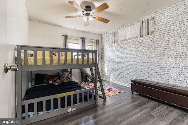 bedroom with brick wall, ceiling fan, and wood finished floors