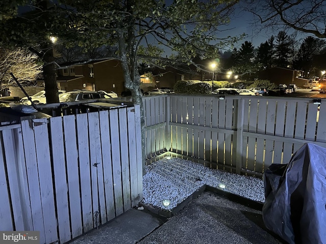 patio at twilight featuring a fenced backyard