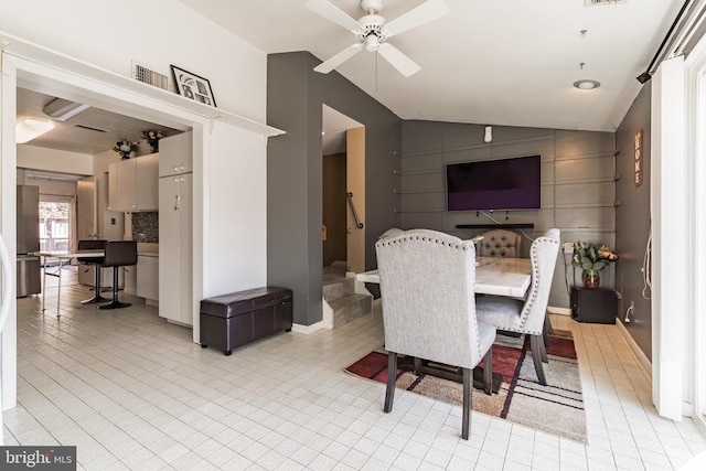 dining room featuring visible vents, lofted ceiling, and a ceiling fan