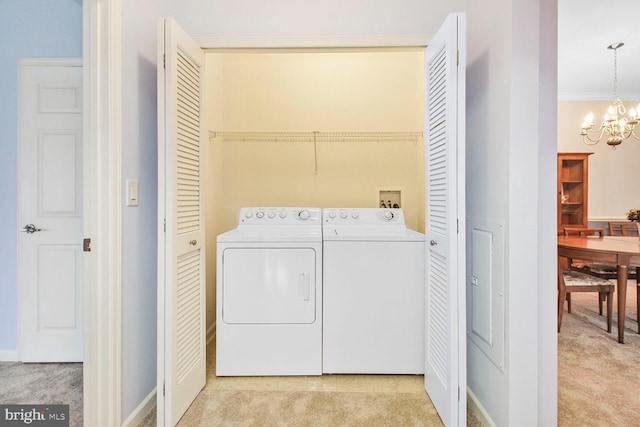 laundry area with a chandelier, laundry area, light colored carpet, and washer and clothes dryer