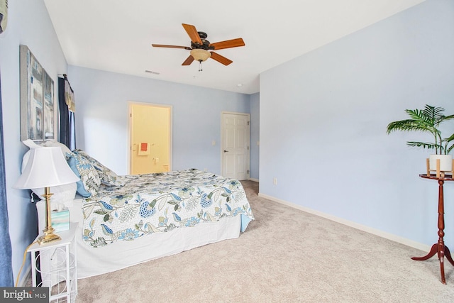 carpeted bedroom with visible vents, baseboards, and ceiling fan