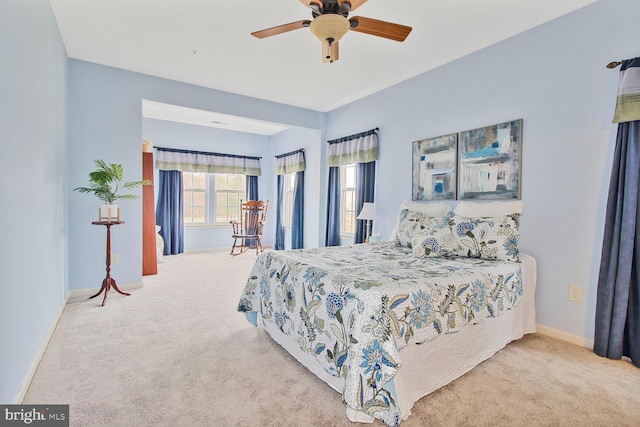 bedroom with ceiling fan, baseboards, and carpet floors