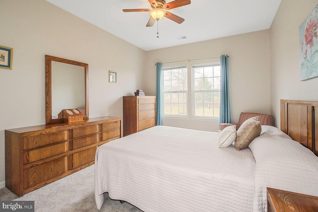 carpeted bedroom featuring visible vents and ceiling fan