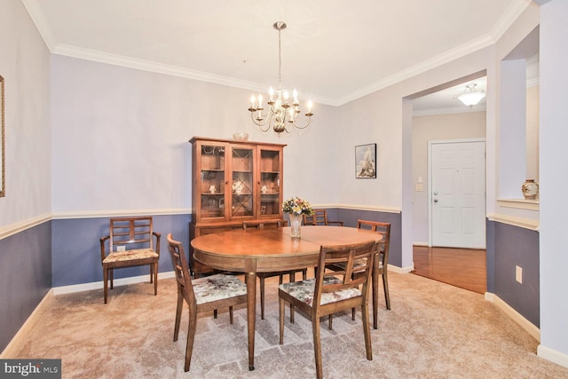 dining area featuring baseboards, light colored carpet, and an inviting chandelier