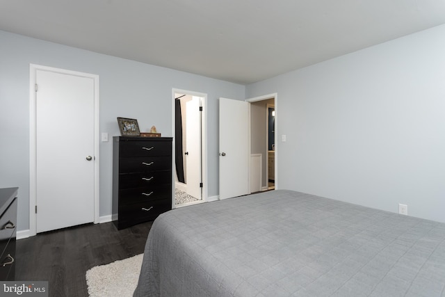 bedroom featuring dark wood-style floors and baseboards