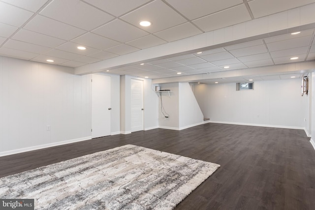 finished below grade area with recessed lighting, dark wood-style flooring, and baseboards