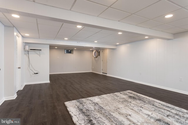 finished basement featuring dark wood-style floors and baseboards