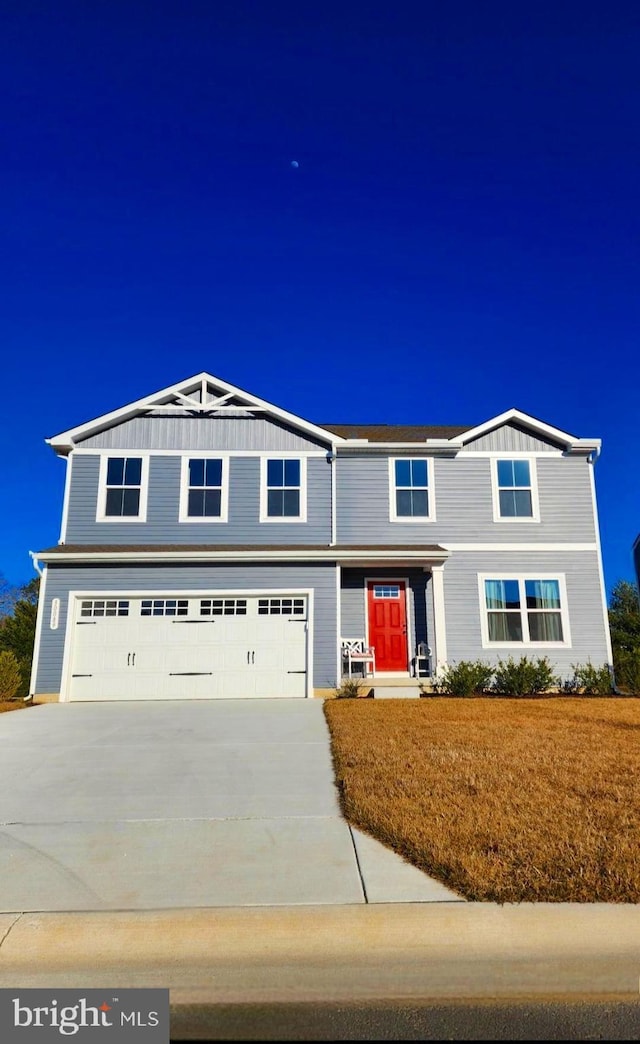 view of front facade featuring a garage, concrete driveway, and board and batten siding