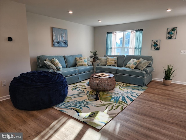 living room featuring recessed lighting, wood finished floors, and baseboards