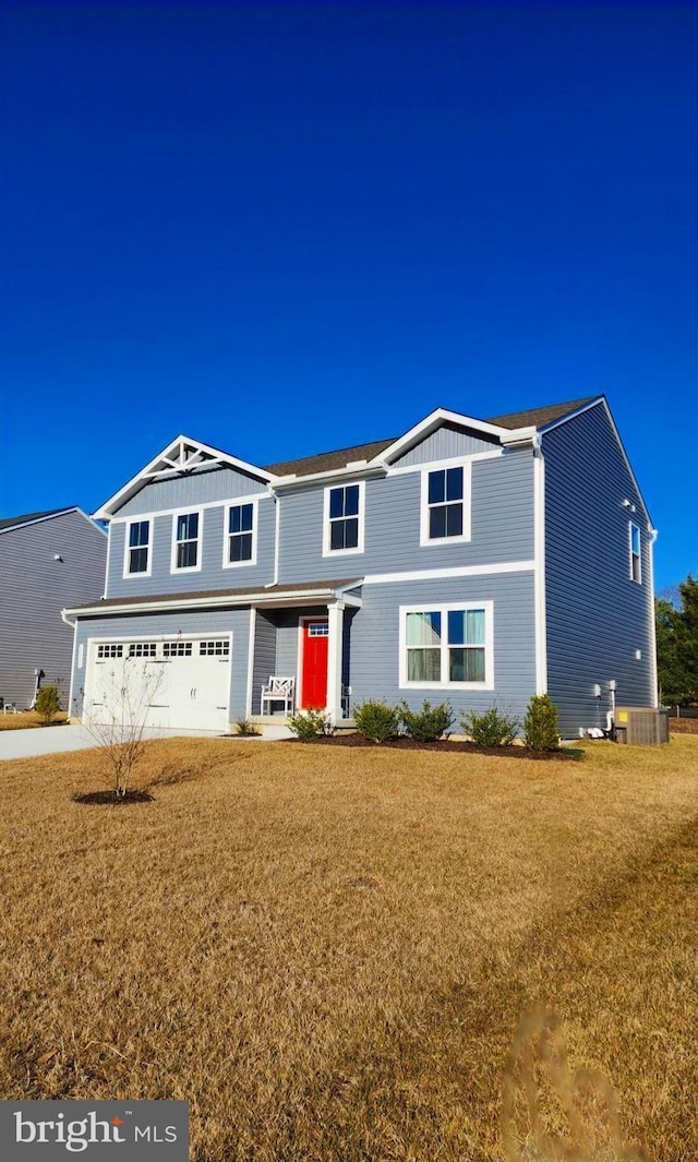 traditional home with a garage, a front lawn, and central AC