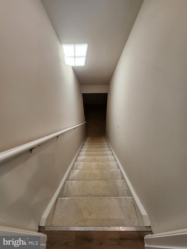 staircase featuring baseboards