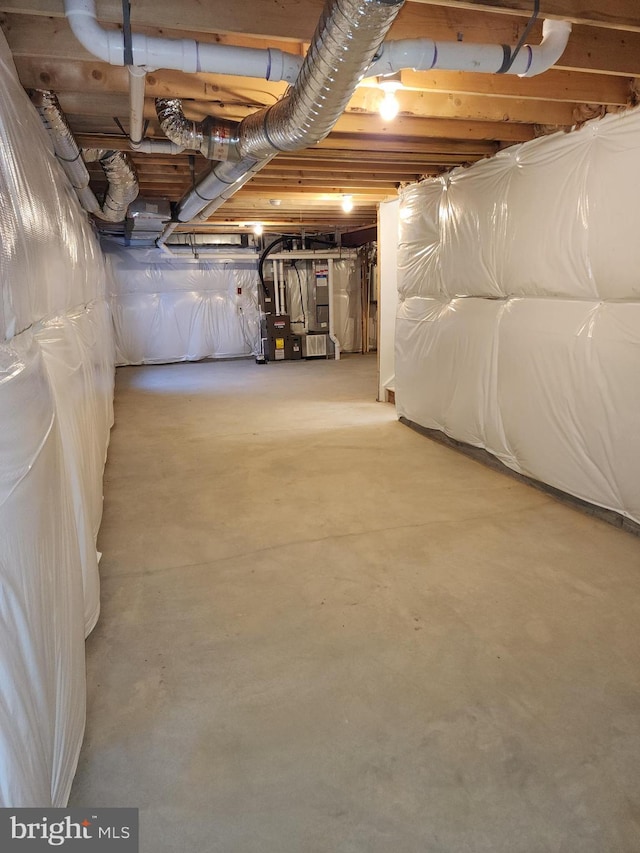 unfinished basement featuring heating unit