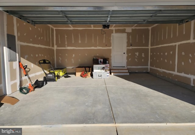 garage featuring a garage door opener and electric panel