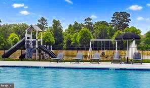 pool featuring fence and playground community