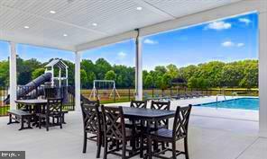 view of patio featuring fence and an outdoor pool