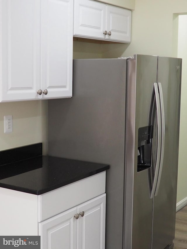 5711 Crownleigh Ct, Burke, VA 22015 - kitchen featuring stainless steel refrigerator with ice dispenser, white cabinets, dark countertops, and wood finished floors