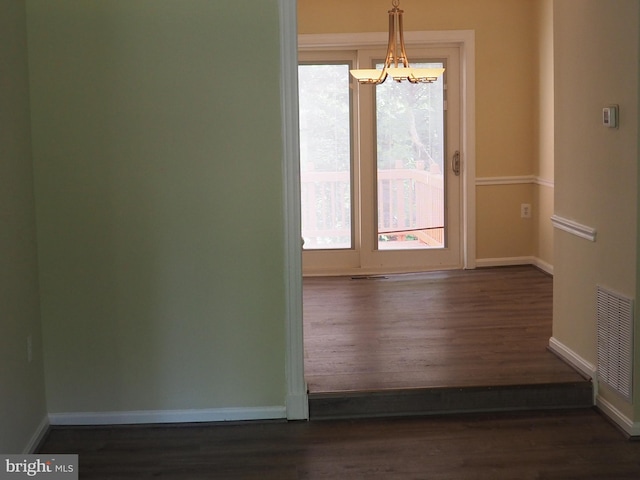5711 Crownleigh Ct, Burke, VA 22015 - unfurnished room featuring dark wood-style floors, baseboards, and a chandelier