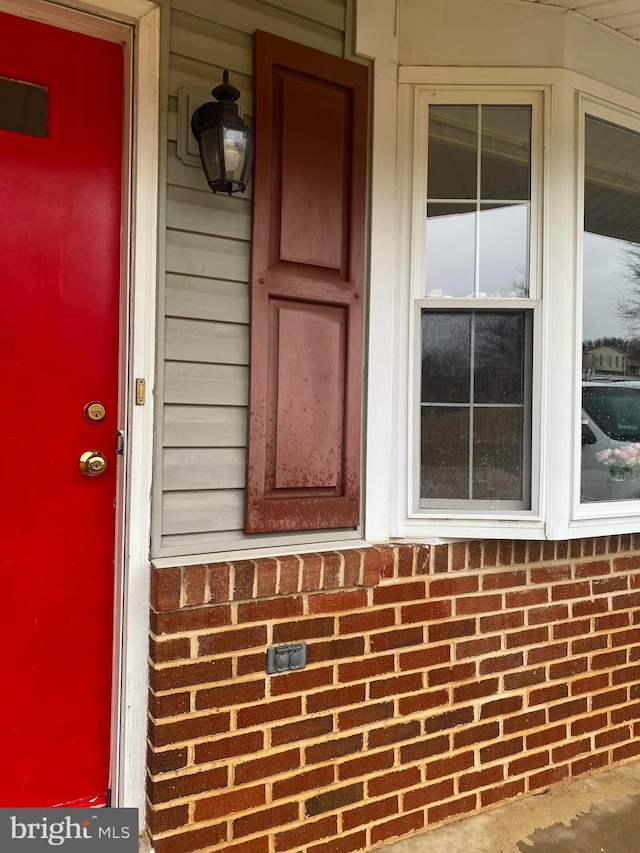 entrance to property with brick siding