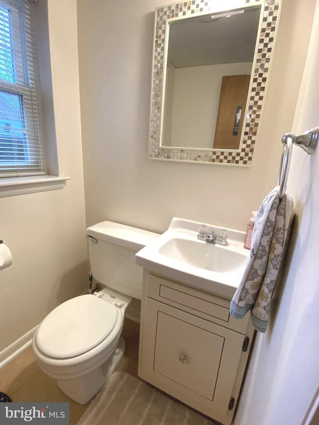 bathroom featuring toilet and vanity