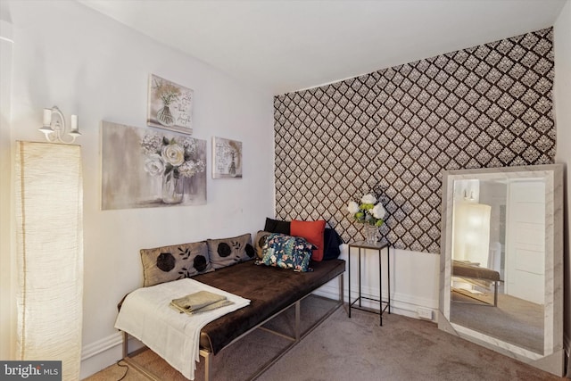 carpeted bedroom with wallpapered walls, baseboards, and an accent wall